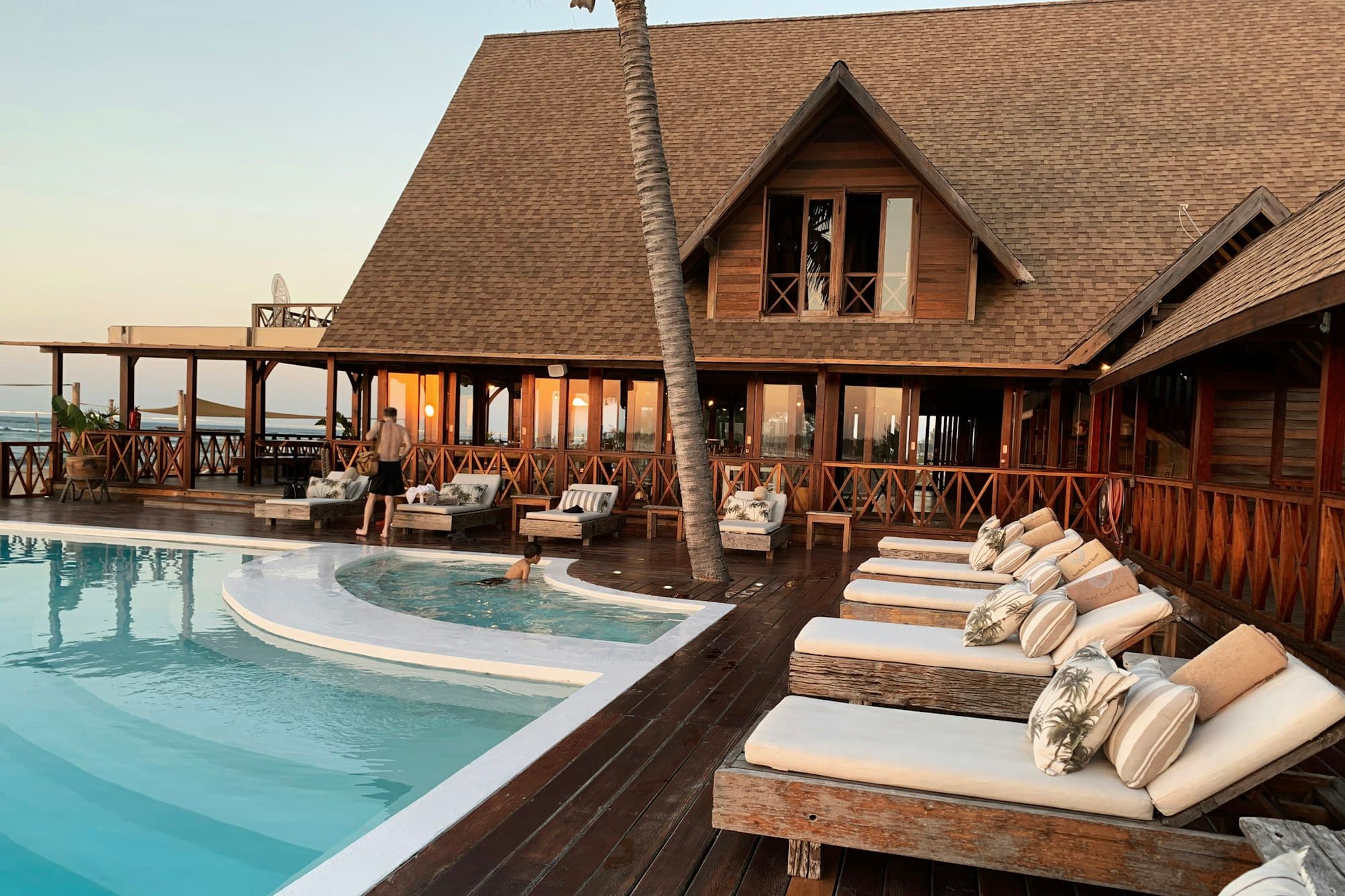 Resort pool beside a wooden lodge